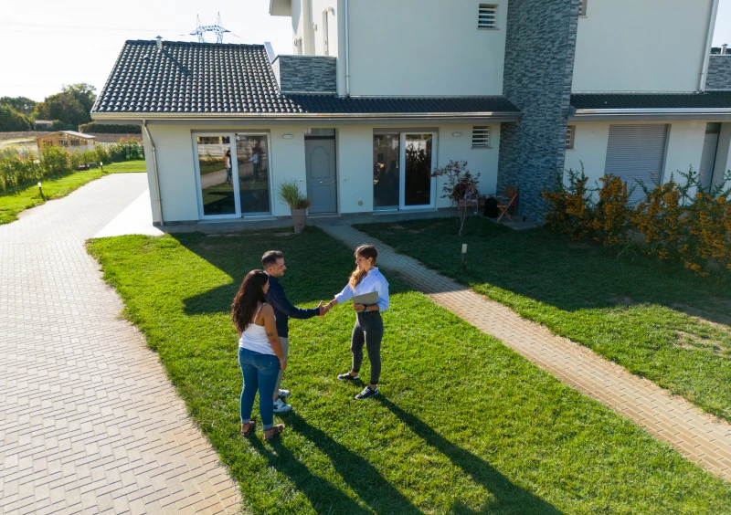 Three people shaking hands outdoors